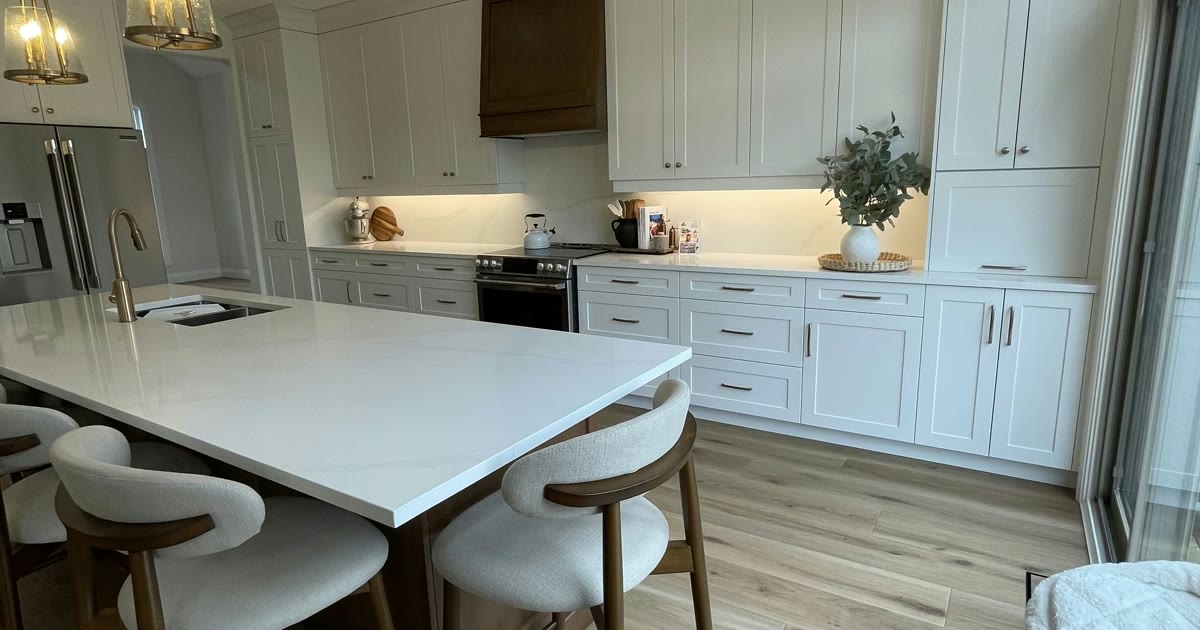 White kitchen with a large island — a HandKind Construction renovation, Brant County